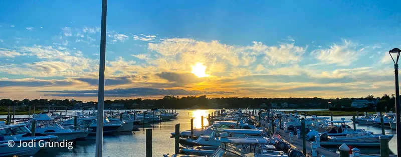 Bass River with boats docked at sunset in Yarmouth, one of these Cape Cod day trips