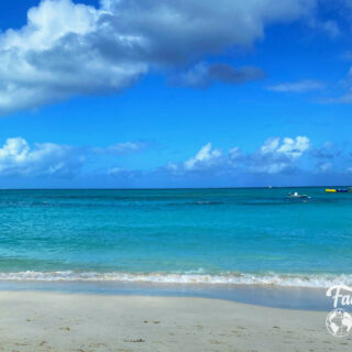 beach small boats with turquoise water and blue sky