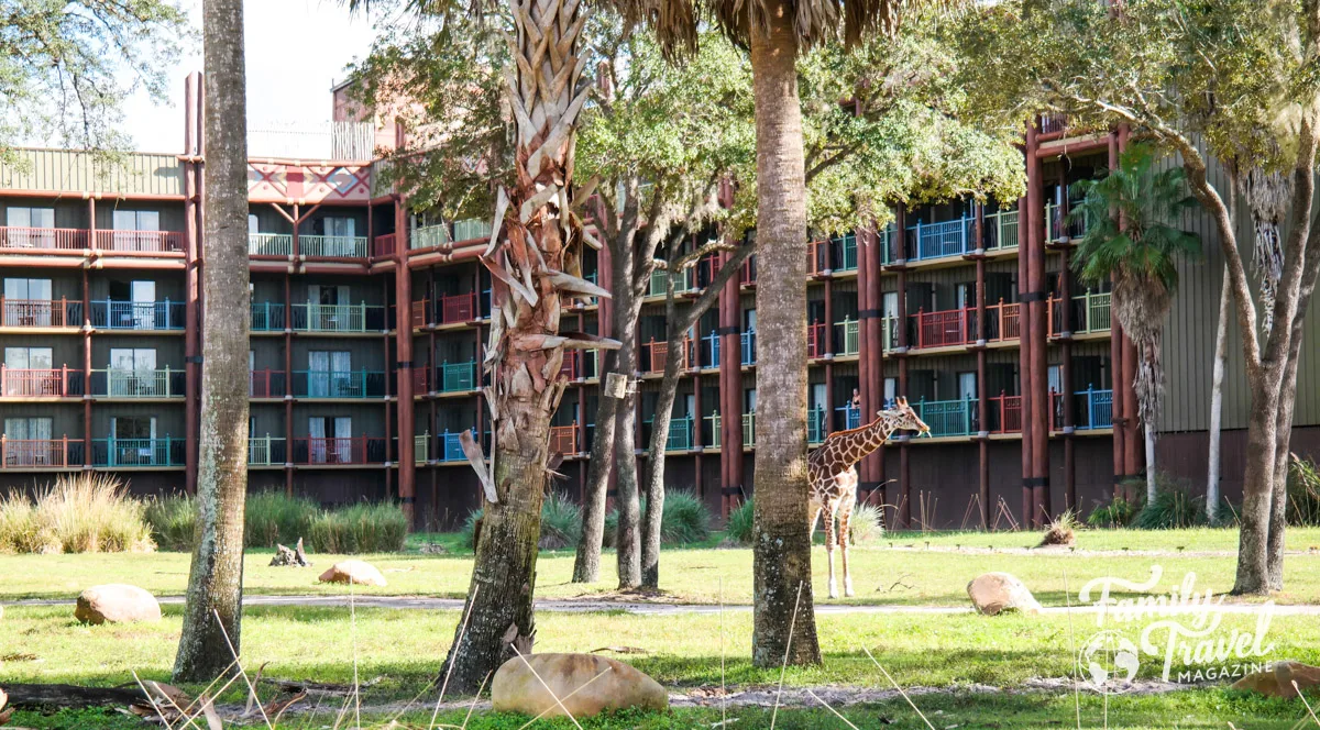 Exterior of Animal Kingdom Lodge with trees and a giraffe