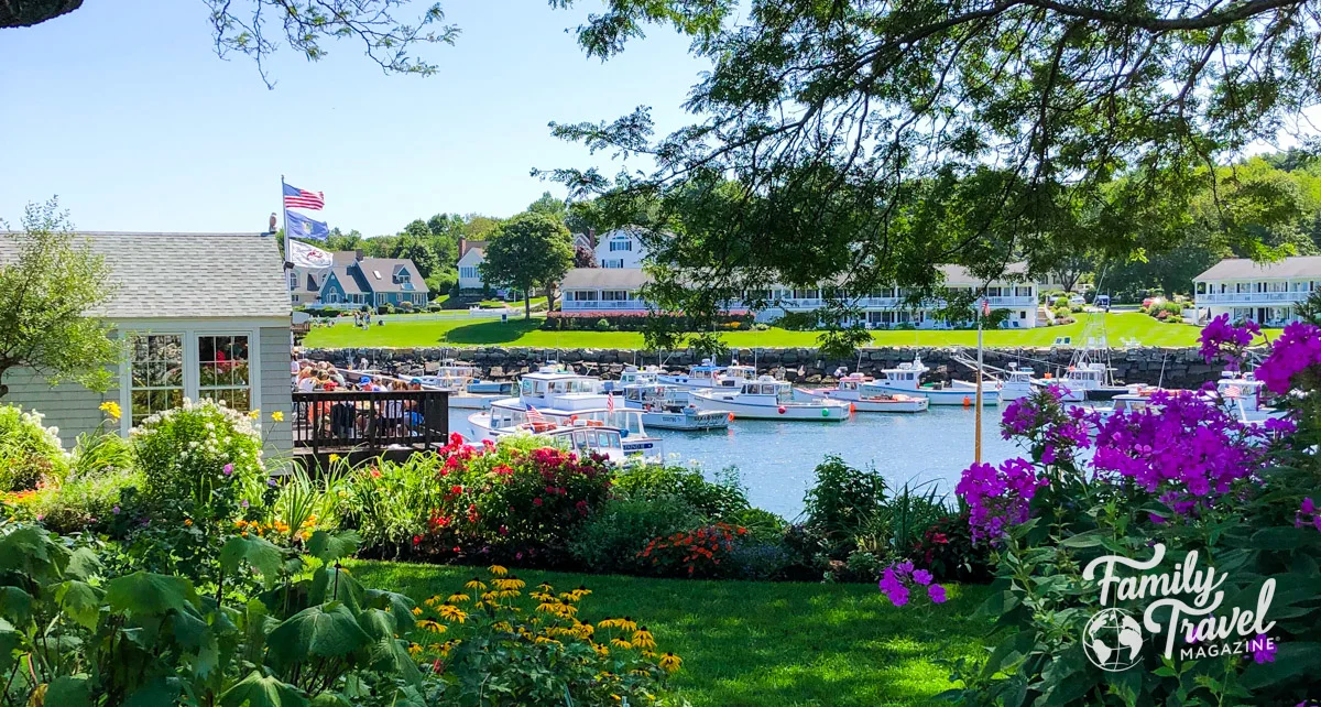 Perkins Cove - one of the best things to do in Ogunquit, with buildings, water, boats, and flowers. 