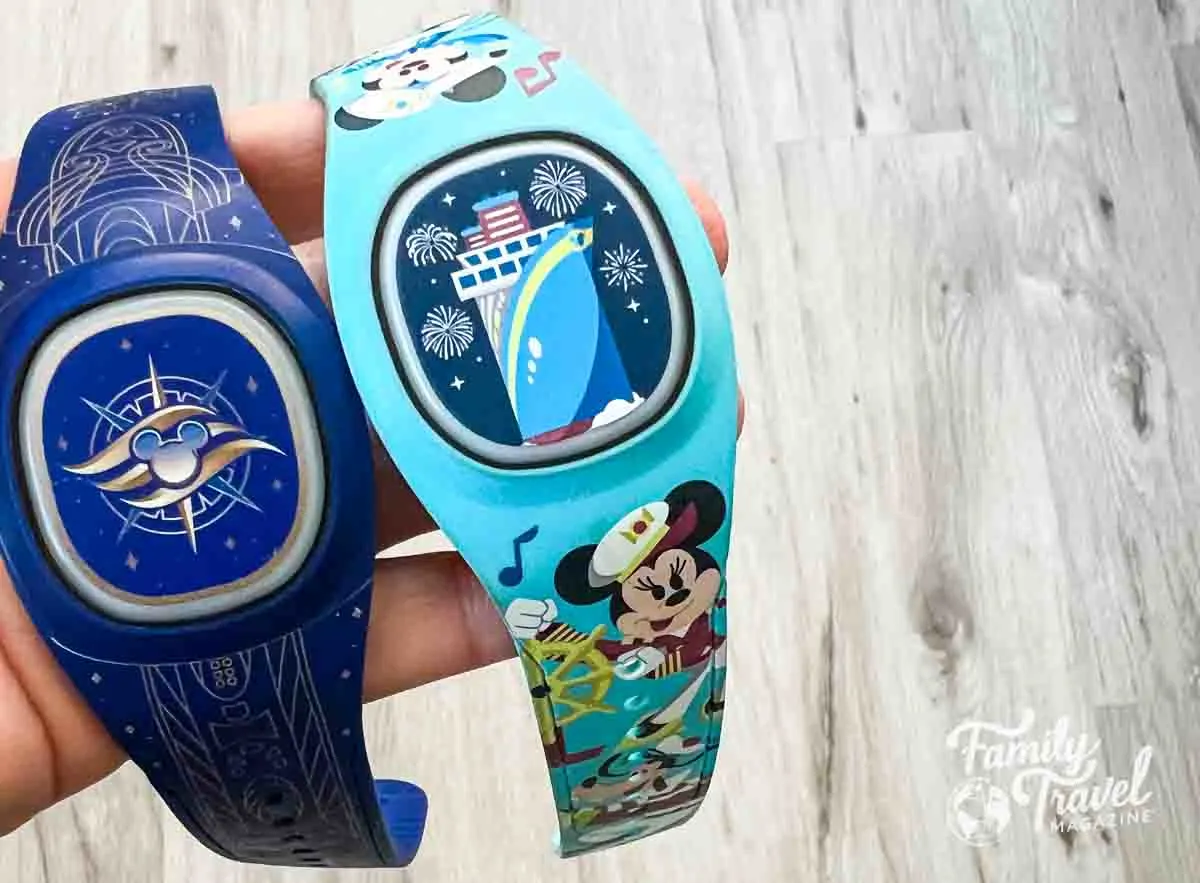 two cruise-themed blue DisneyBands in a hand. 