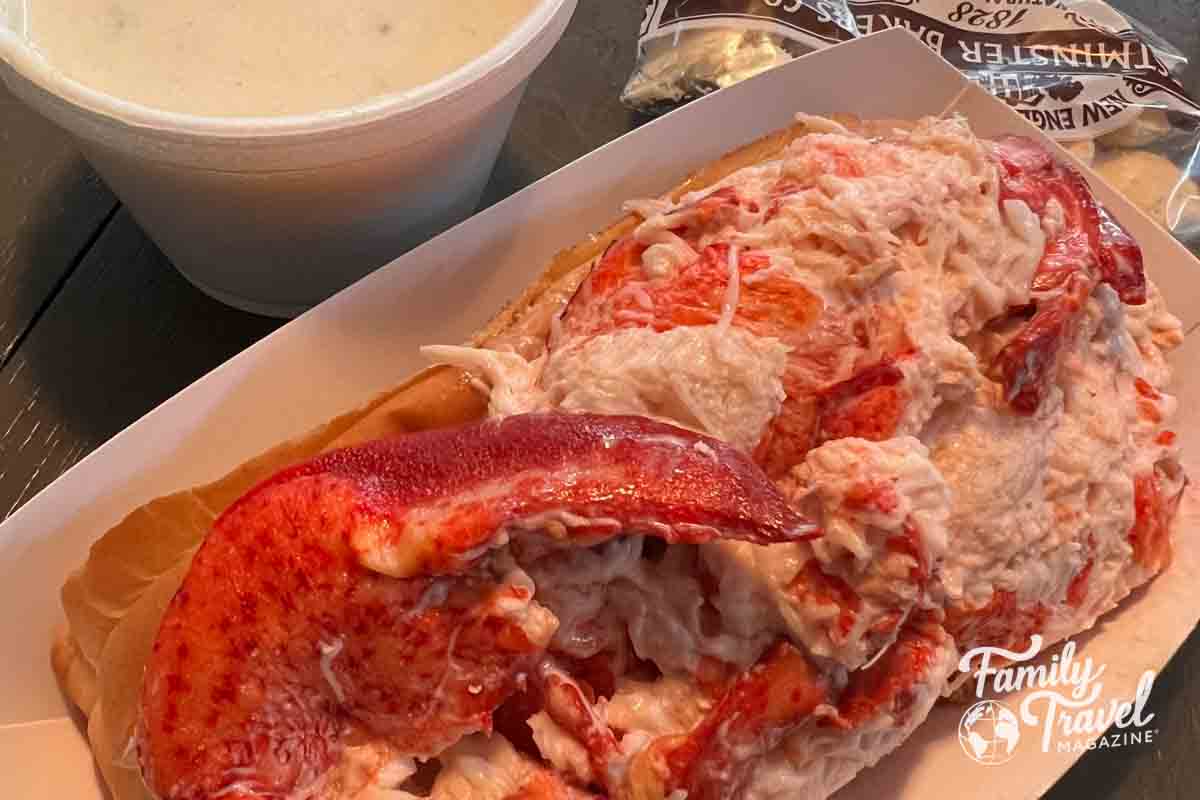 Lobster roll with a cup of chowder and oyster crackers