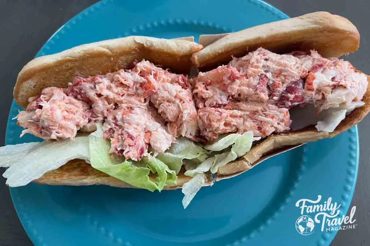 Lobster roll with lettuce on a blue plate