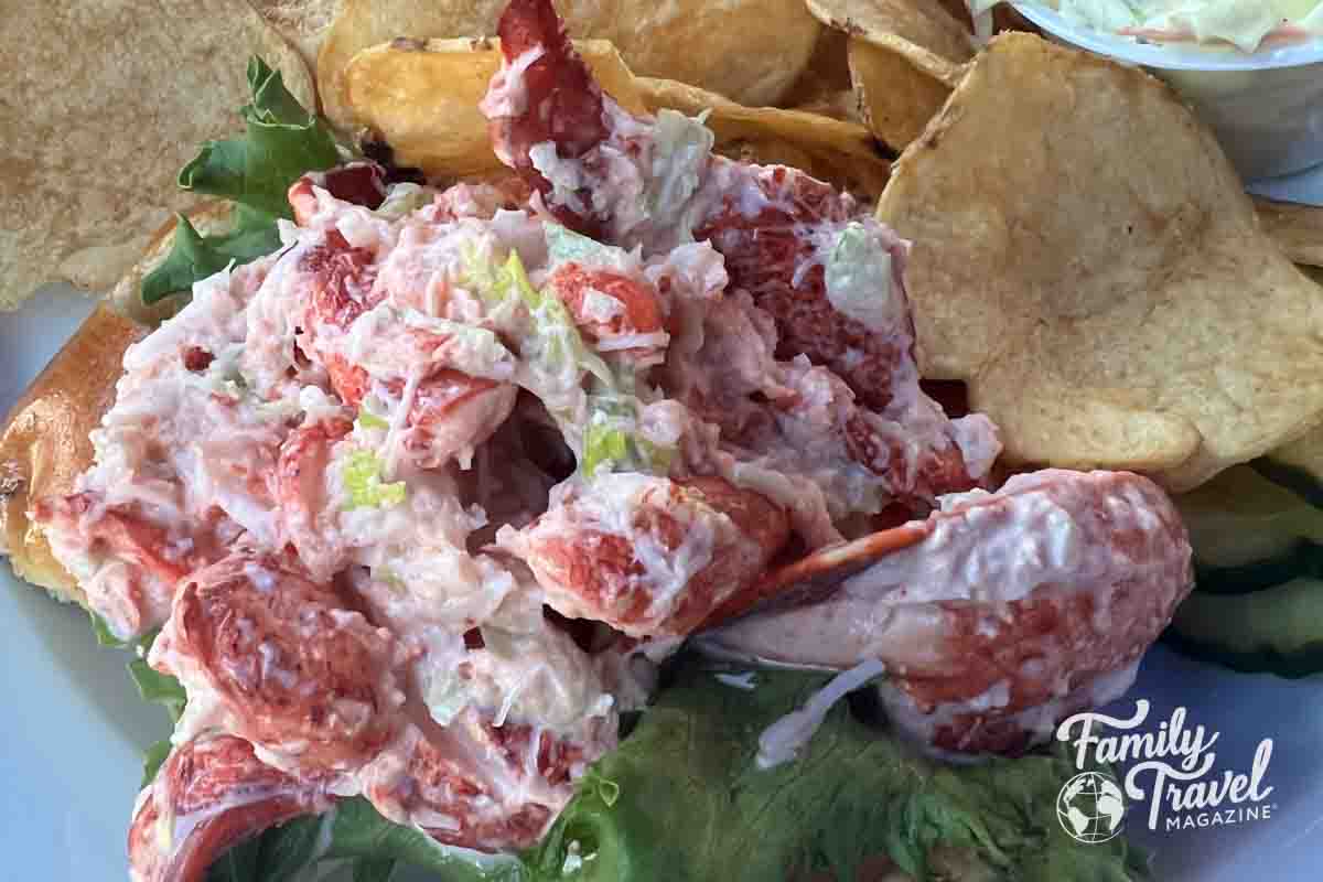 Lobster roll on a bed of lettuce with homemade potato chips