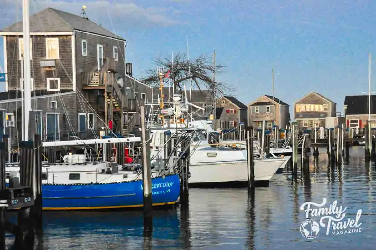 Docked boats in front front of gray waterfront buildings