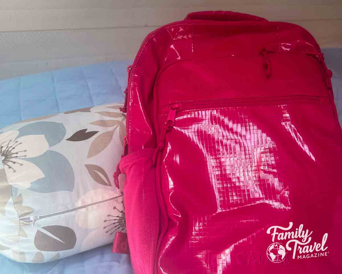 Pink backpack on bed