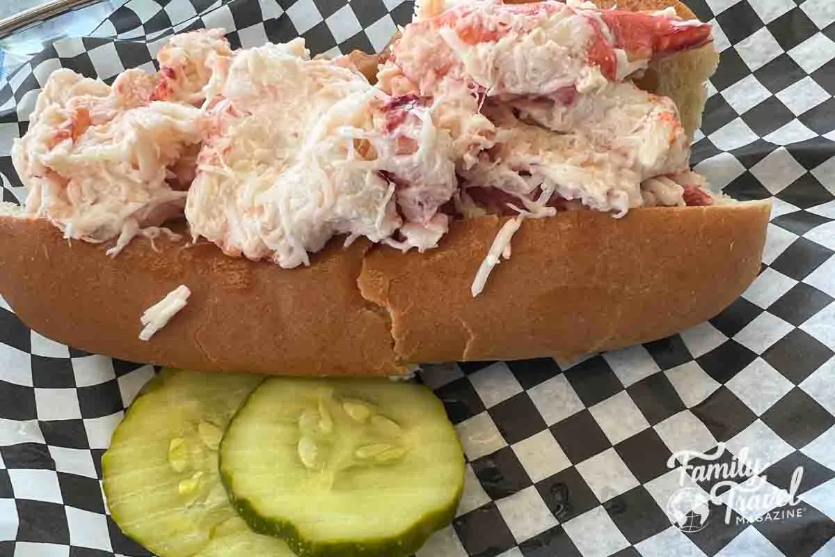 Lobster roll with a pickle slice