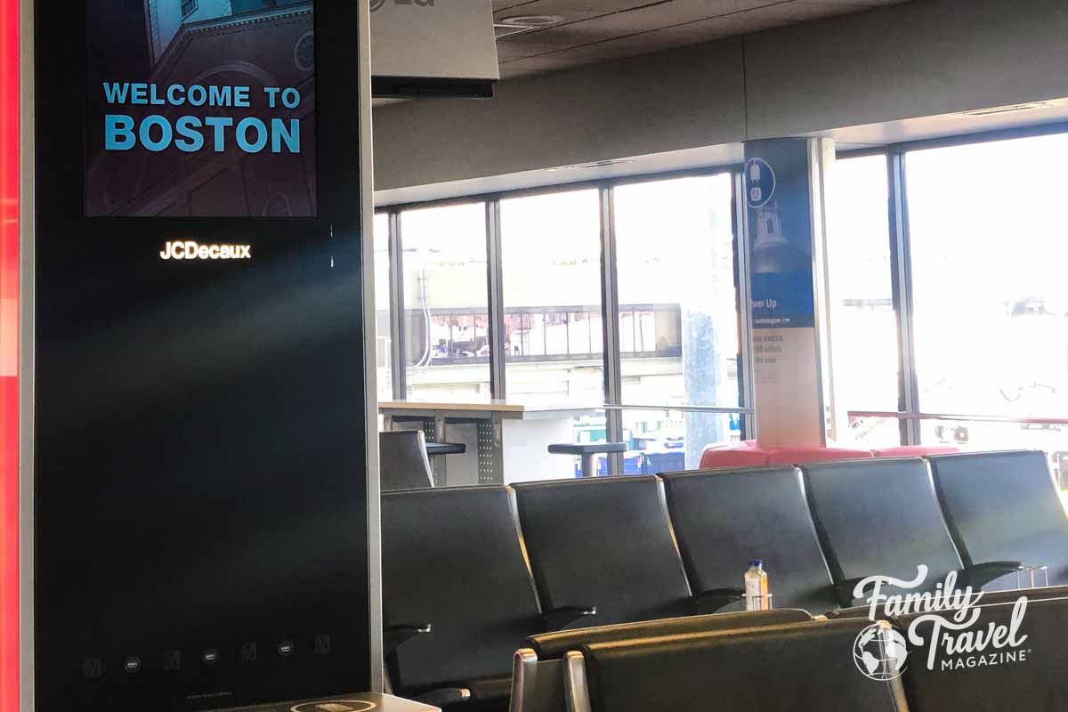 Seating at Boston airport with welcome to Boston sign