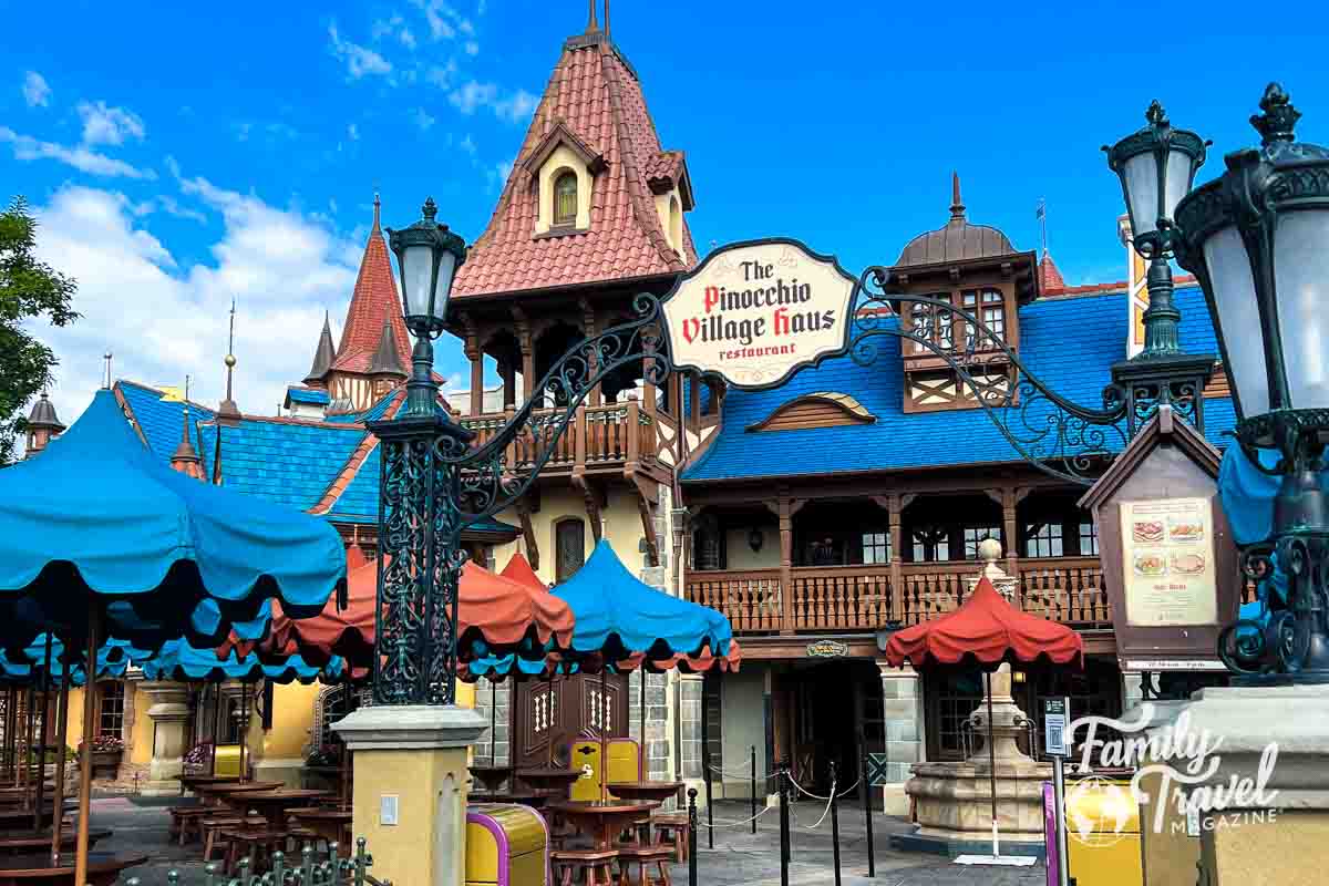 Exterior of Pinocchio's Village Haus with umbrellas and tables outside