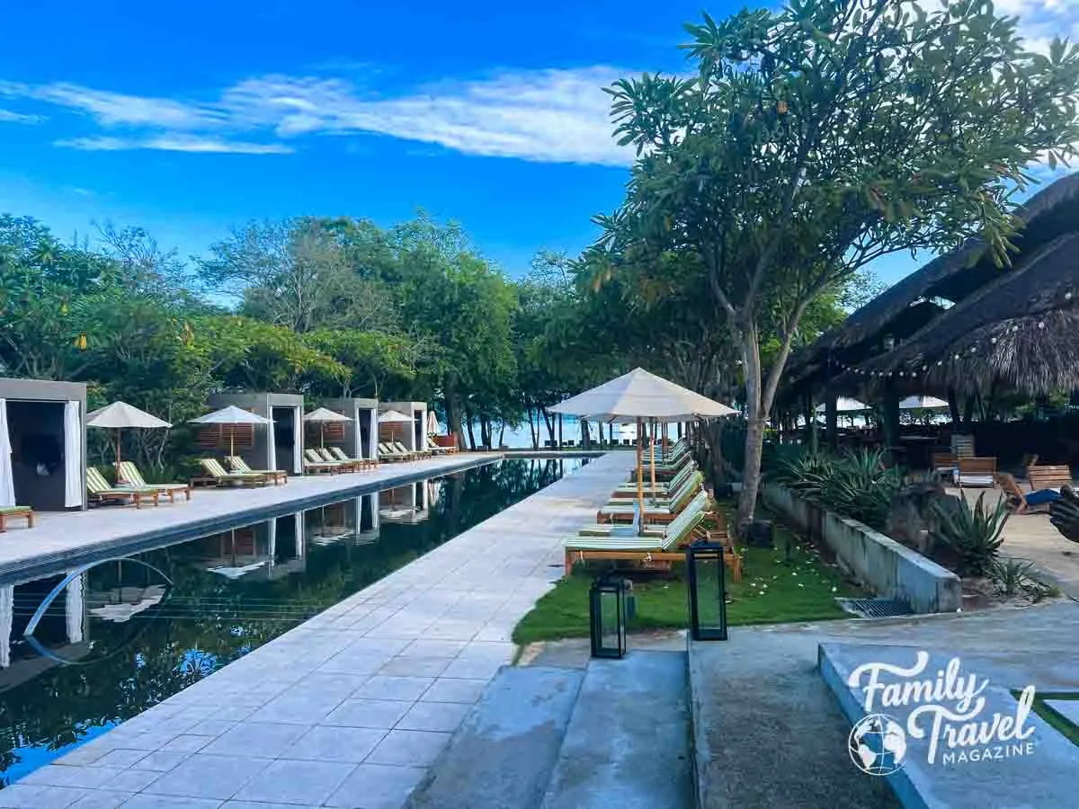 Pool with cabanas and beach chairs