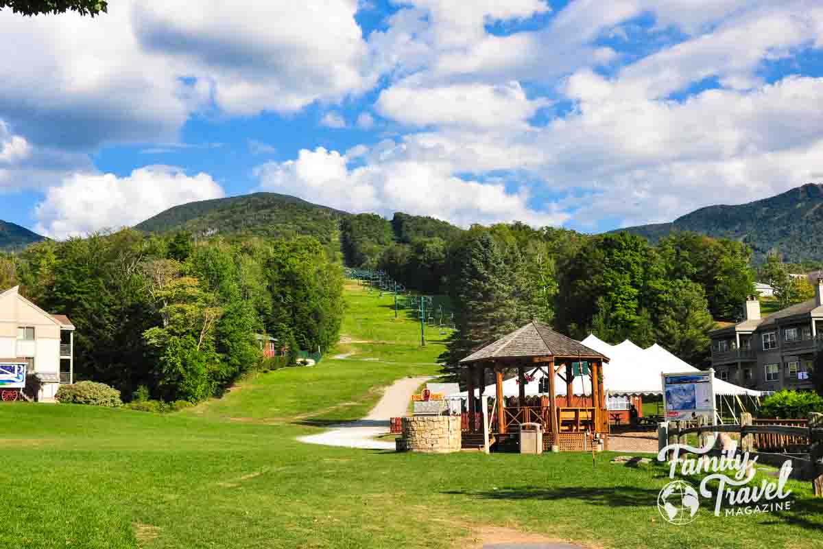 Gazebo and ski lift among mountains and buildings 