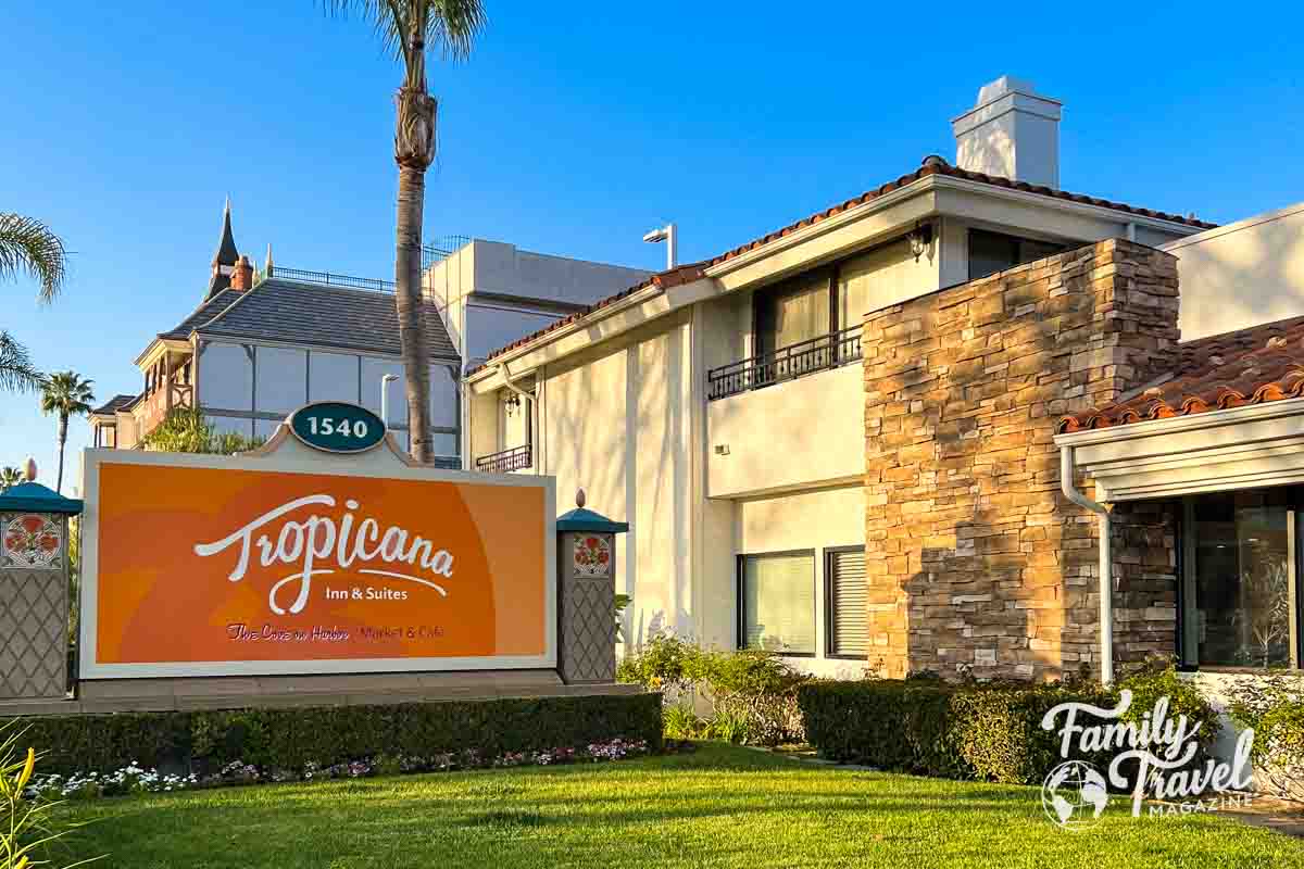 The exterior of Tropicana Inn & Suites with a large orange sign.