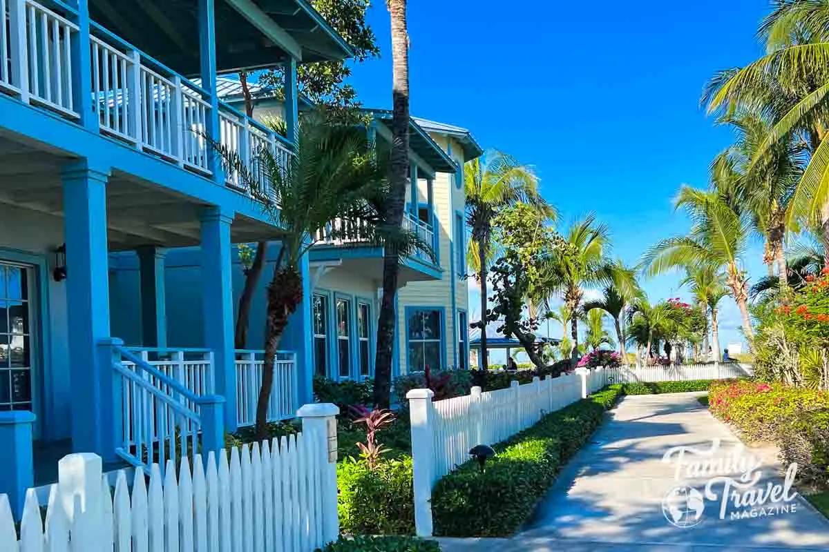 Buildings with patios surrounded by white picket fence