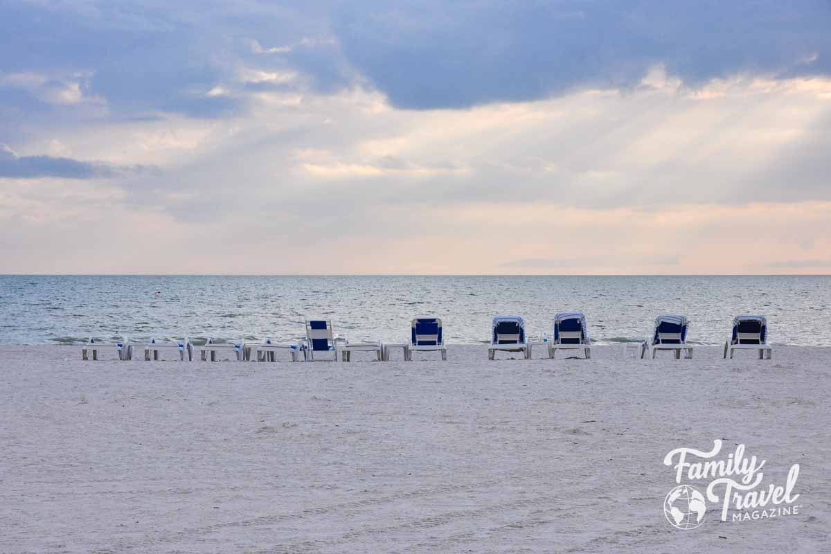 Beach lounge chairs lined up 