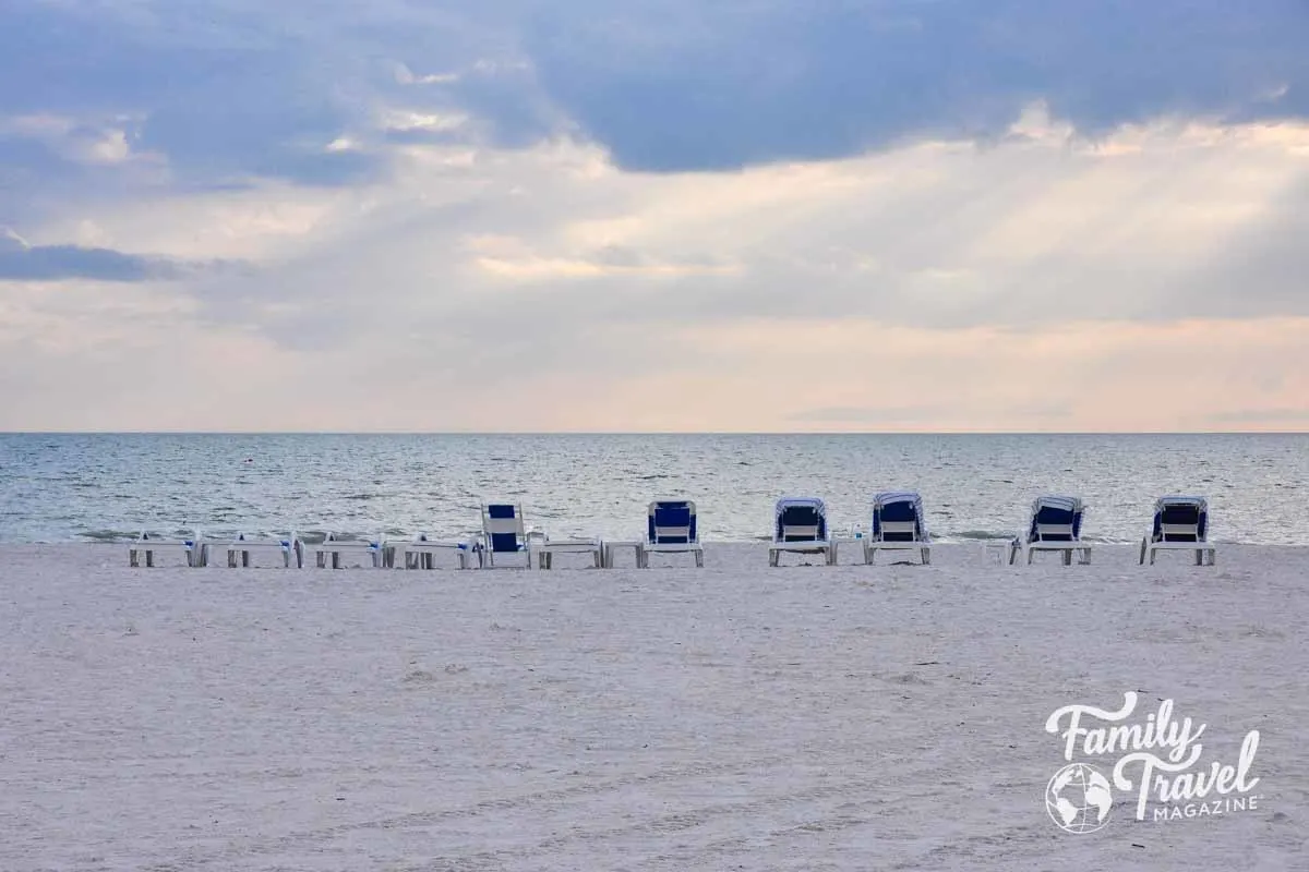 Beach lounge chairs lined up 