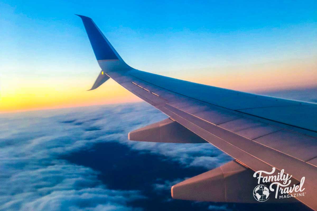 Plane above cloud at sunset