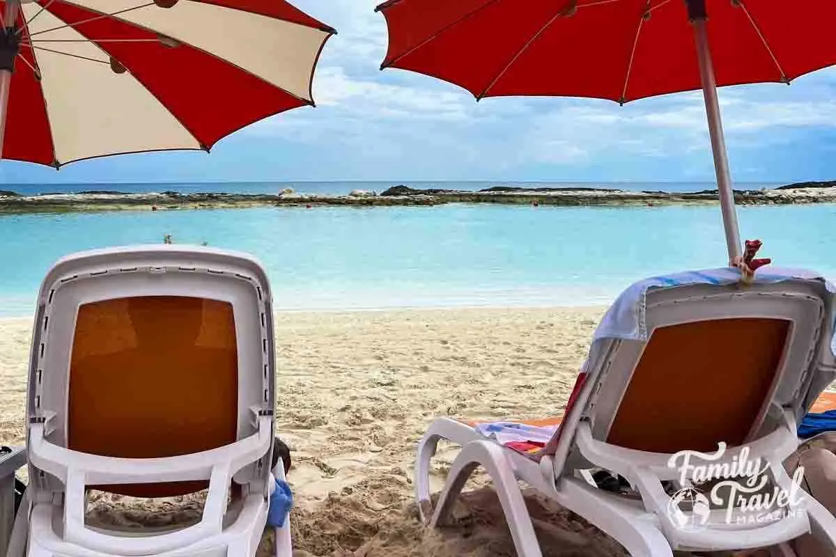 Beach chairs on beach with umbrellas