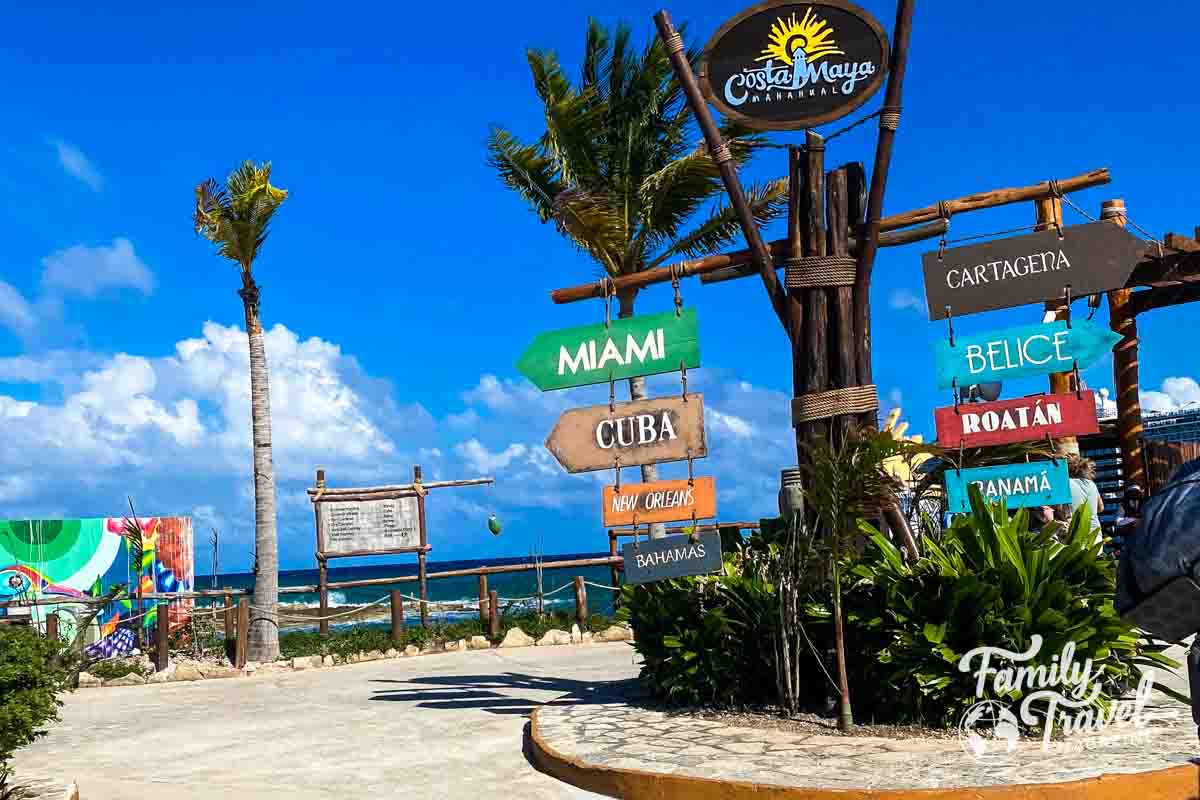 Sign showing directions to popular destinations by waterfront 