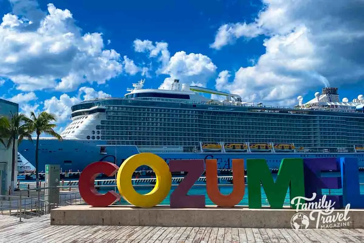 Ship docked behind Cozumel sign