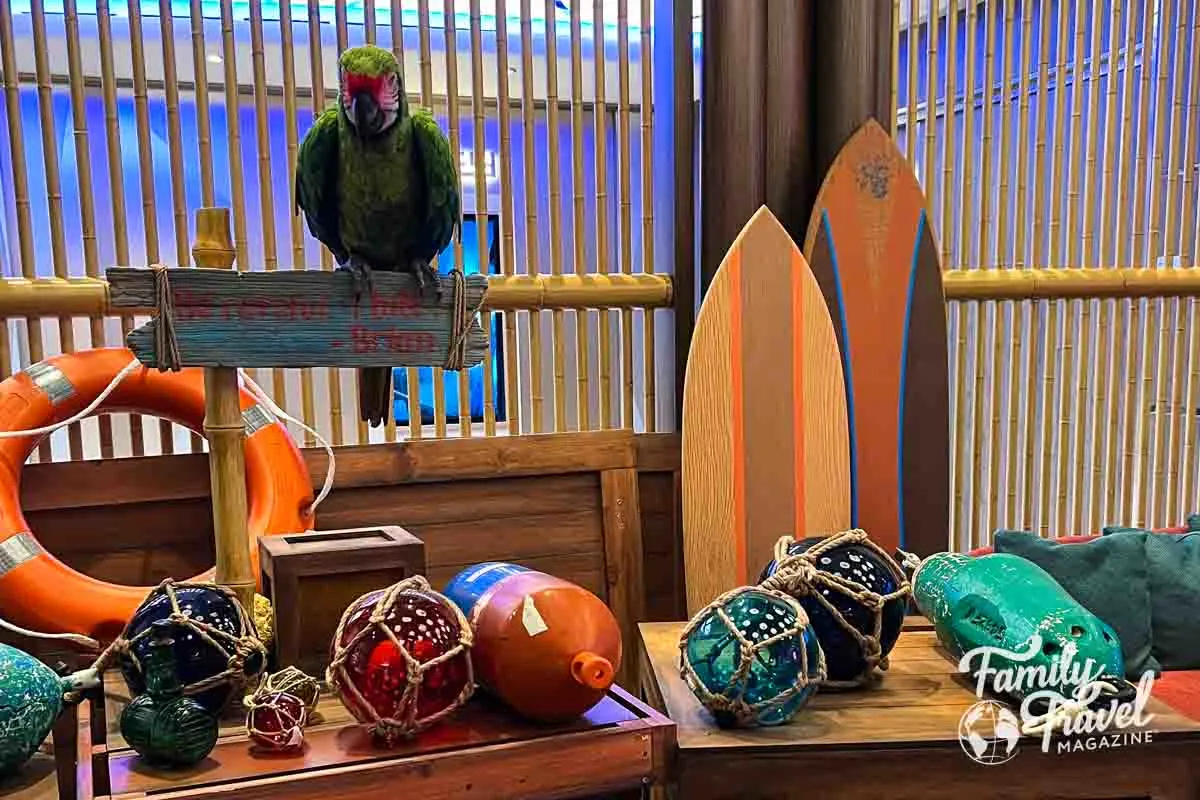 Parrot audio animatronic with surfboard and other ocean decor