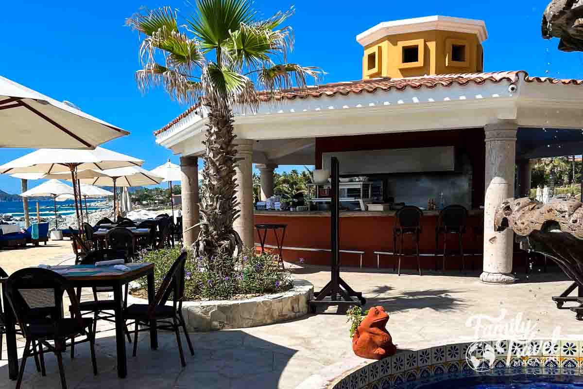 Poolside bar with tables and umbrellas