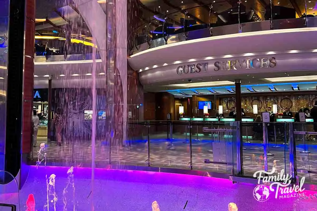 Guest services with bright purple lights and fountains outside