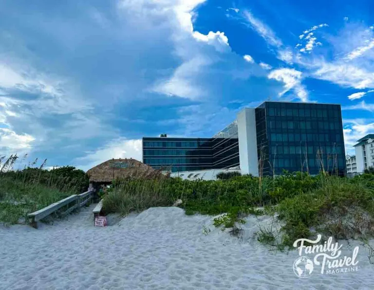 Exterior of the Hilton Hotel from the beach with a path leading to the hotel