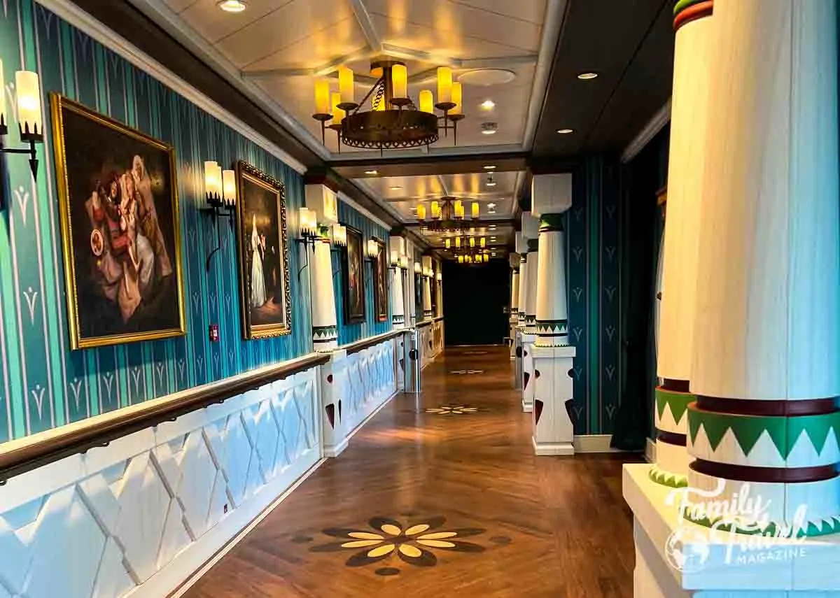 Hallway leading to Arendelle restaurant with pictures on the wall and columns