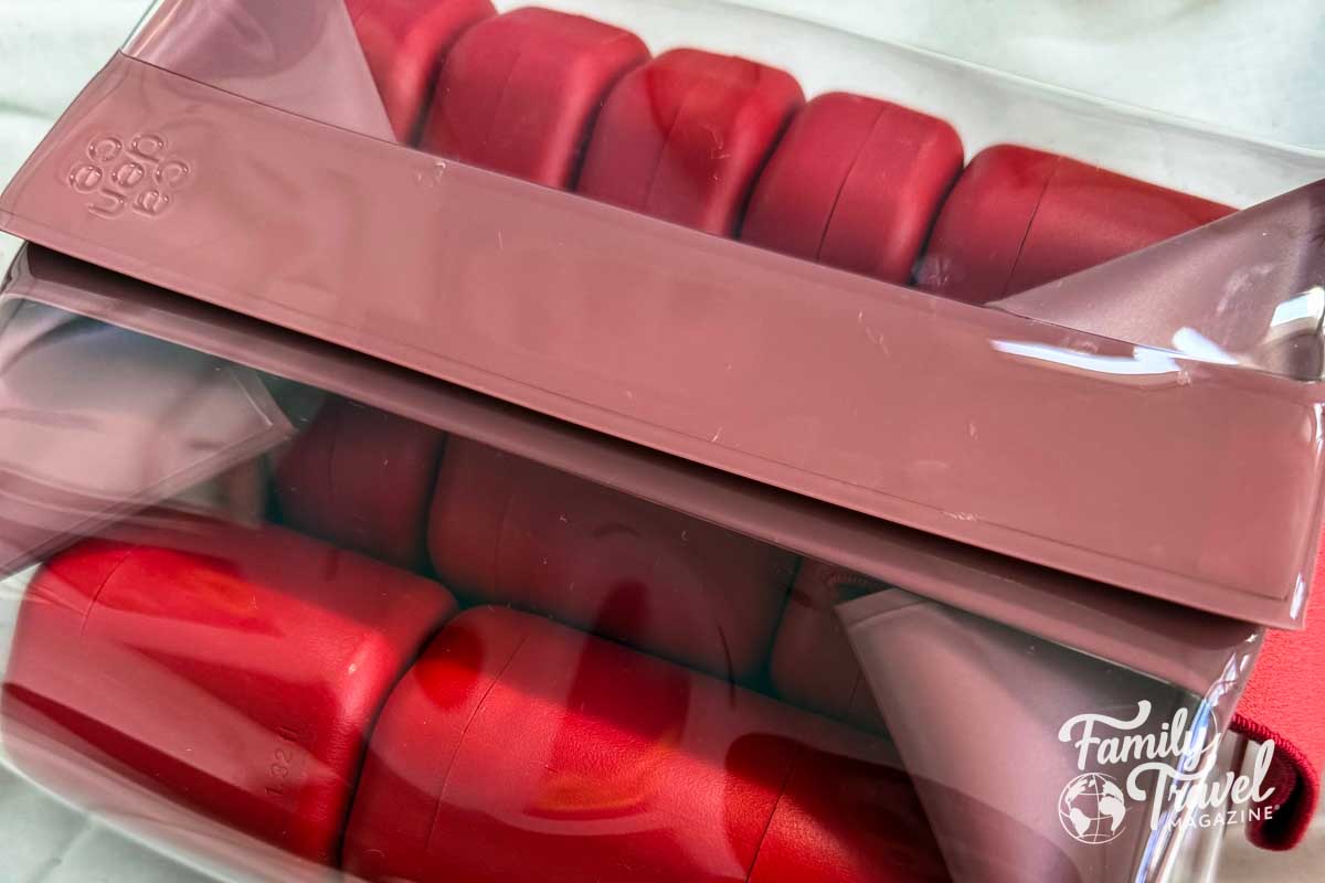 Red Cadence Capsules in a clear and red toiletry bag. 