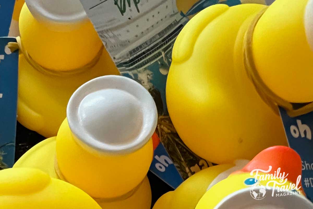 Rubber ducks with white hats in a pile