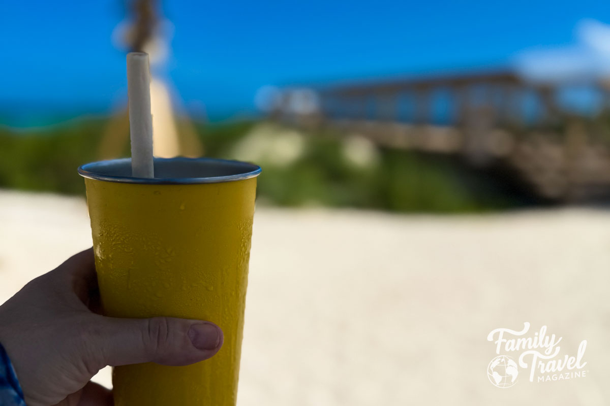 Yellow metal cup in front of beach