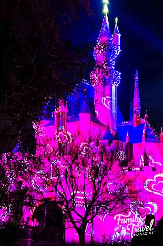 Pink and white heart projection on Disneyland Castle