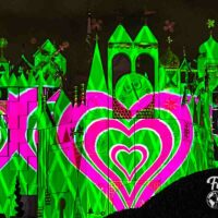 Green with pink heart projection on it's a small world.