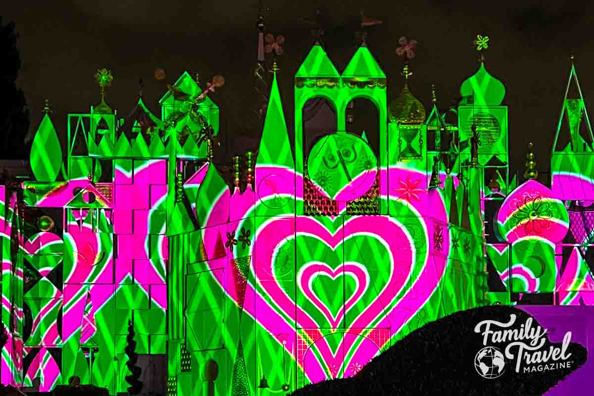 Green with pink heart projection on it's a small world.