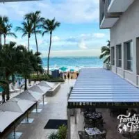 view of beach, umbrellas, and outdoor restaurant