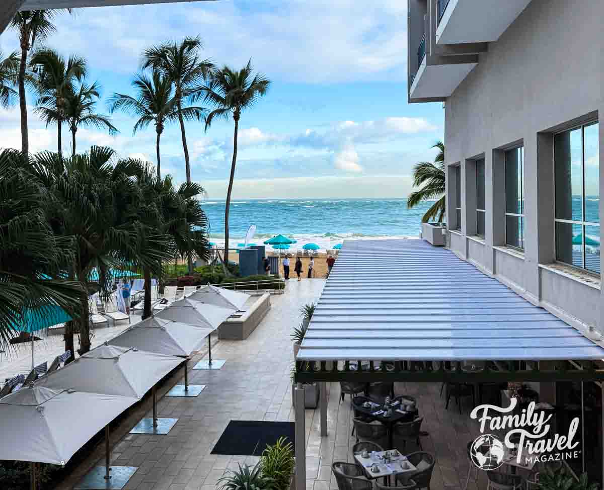 view of beach, umbrellas, and outdoor restaurant