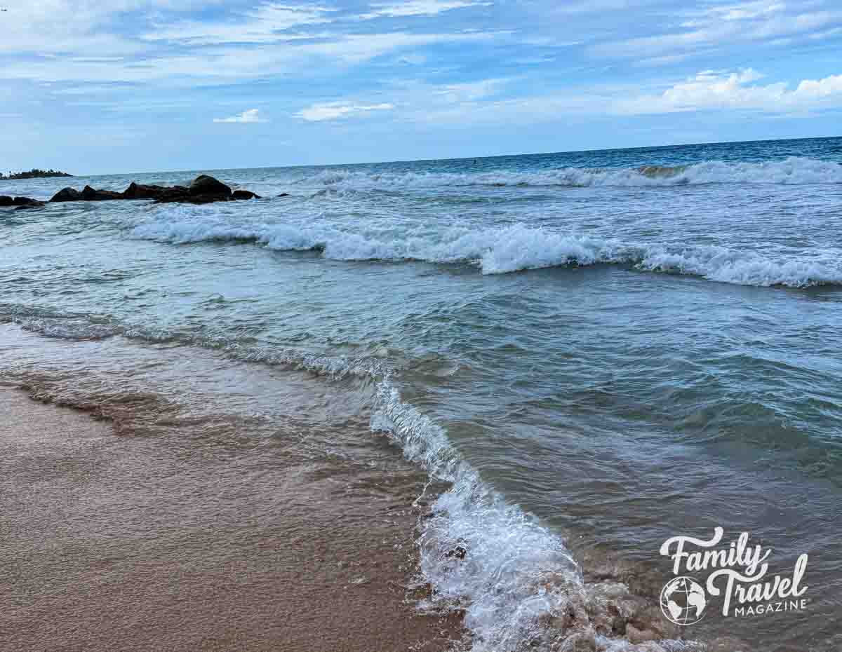 Beach with waves and rocks in ocean