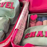 Aqua and pink pouches in a suitcase