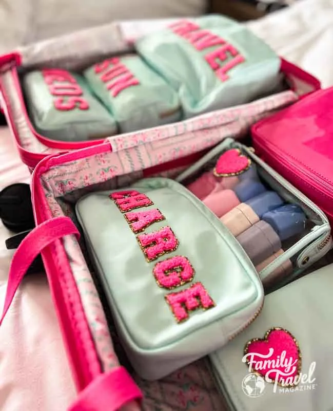 Aqua and pink pouches in a suitcase 